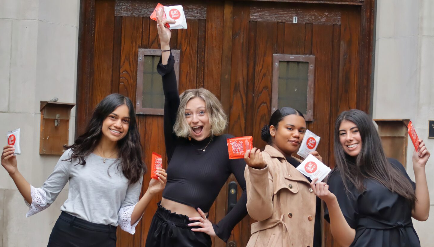 Mission Menstruation's Co-Founders and members show off MHPs outside of an MSU building